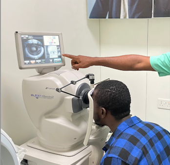 SpecSMART Eye Clinic Ikeja Optomterist doing 
An OCT exam with a male patient