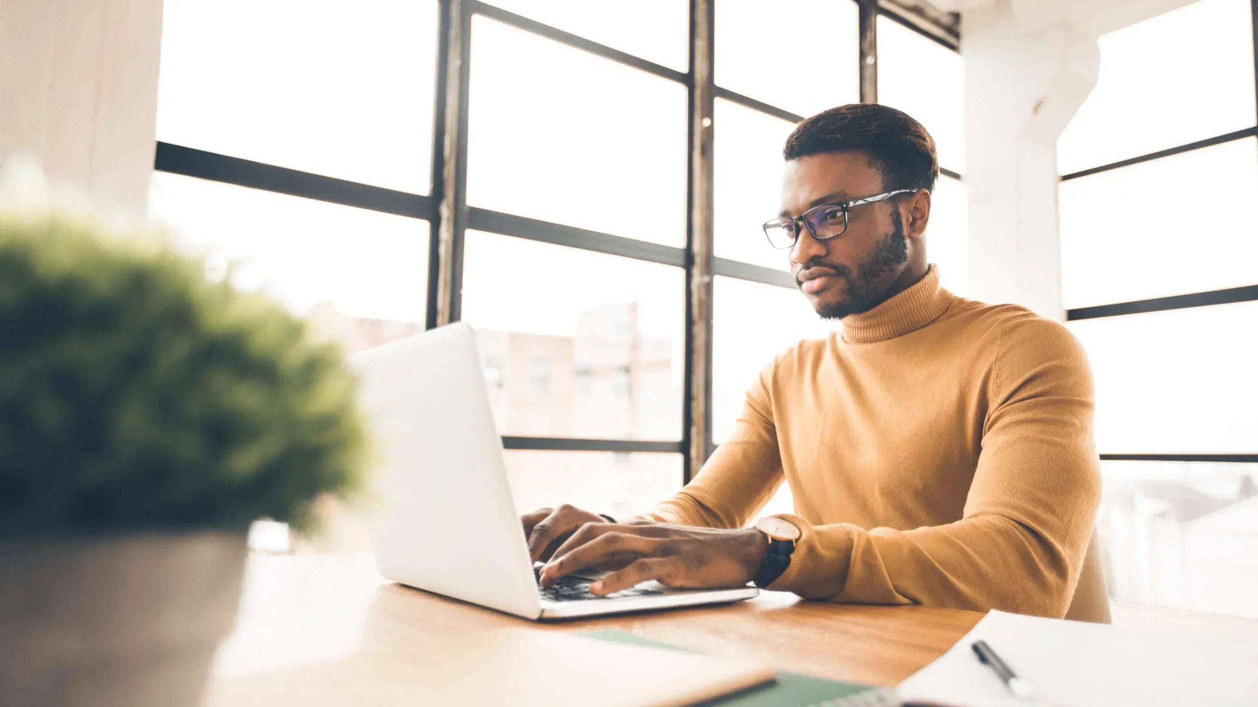 Man wearing glasses using a computer | SpecSMART Eye Clinic Ikoyi