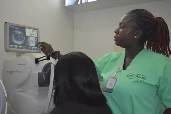 An optometrist with a patient| SpecSMART Eye Clinic Ikoyi
