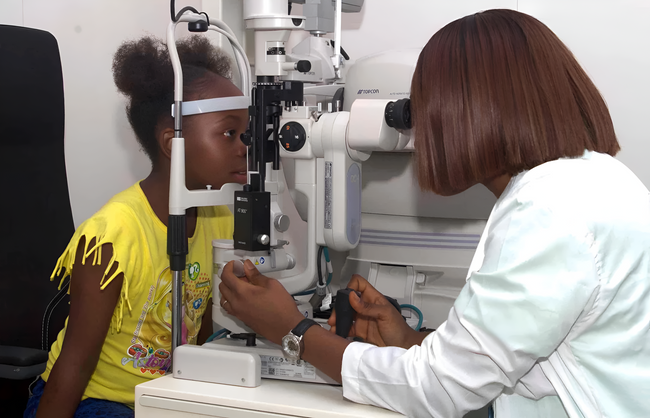 Our Optometrist doing an eye test for a child in our Facility| SpecSMART Eye Clinic Ikeja
