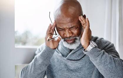 A man struggling with headaches| SpecSMART Eye Clinic Ikoyi