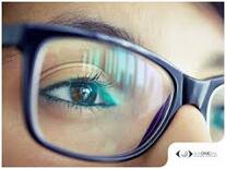 Close-up of an eye wearing glasses reflecting a digital screen| SpecSMART Eye Clinic Ikoyi