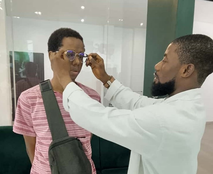 Ikeja Optician checking frame fit with patient 