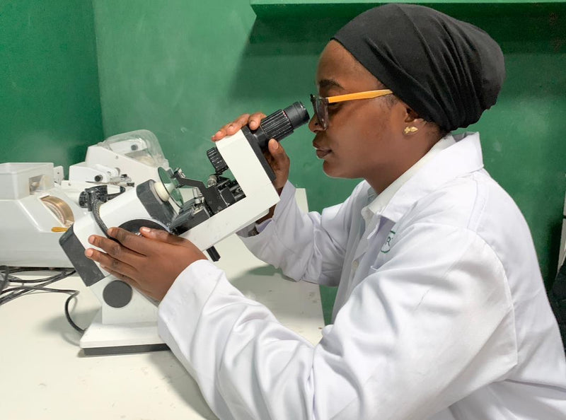 Ikoyi Optician examining lens with lensometer