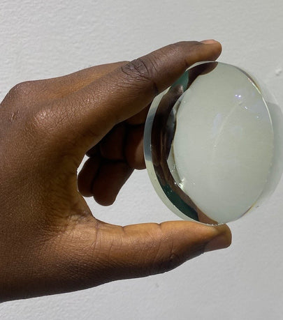 Ikoyi Optician holding lens