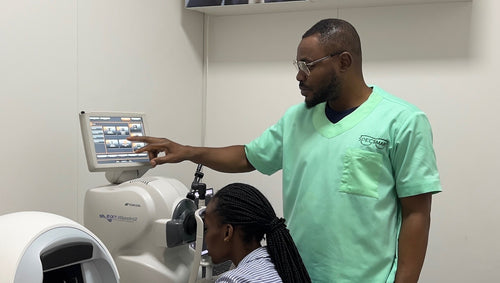 Optometrist doing OCT test with patient